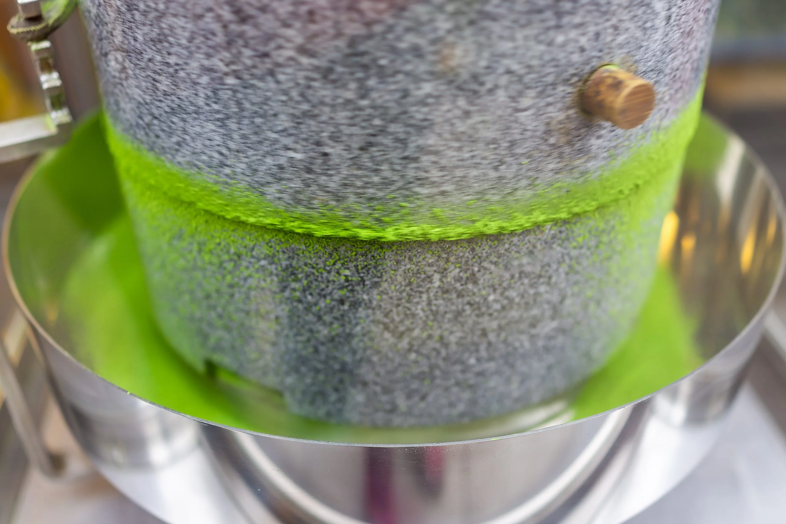 A matcha milling machine used to grind up tea leaves into finished matcha powder.